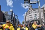Tourists wearing costumes driving Mario Kart style go-karts through Ginza 4-chome in Tokyo during a street kart tour with Kartzilla Go Kart.